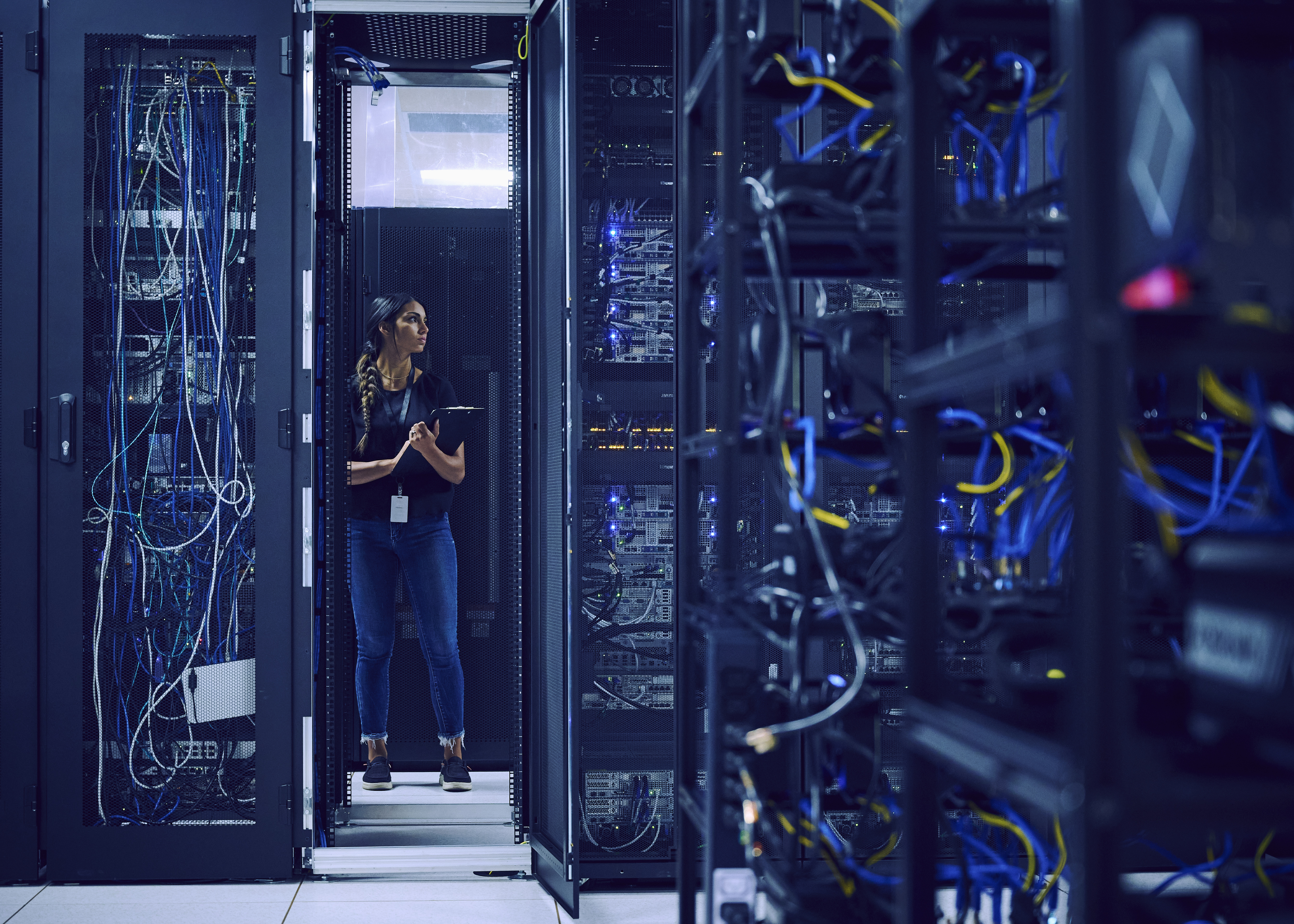 USA, Utah, St. George, Female technician standing in server room