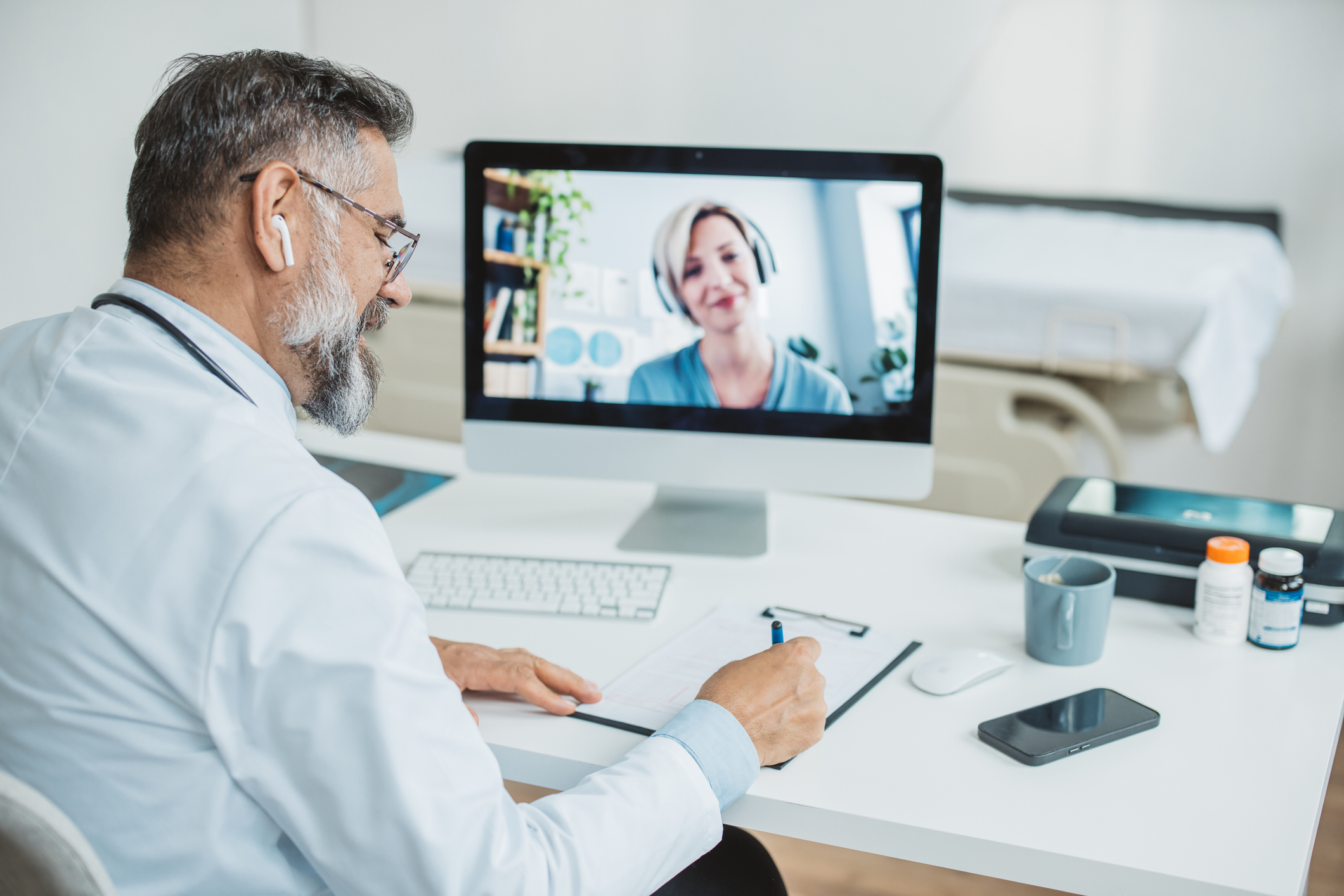 Doctor talking while explaining medical treatment to patient through a video call  in the consultation.