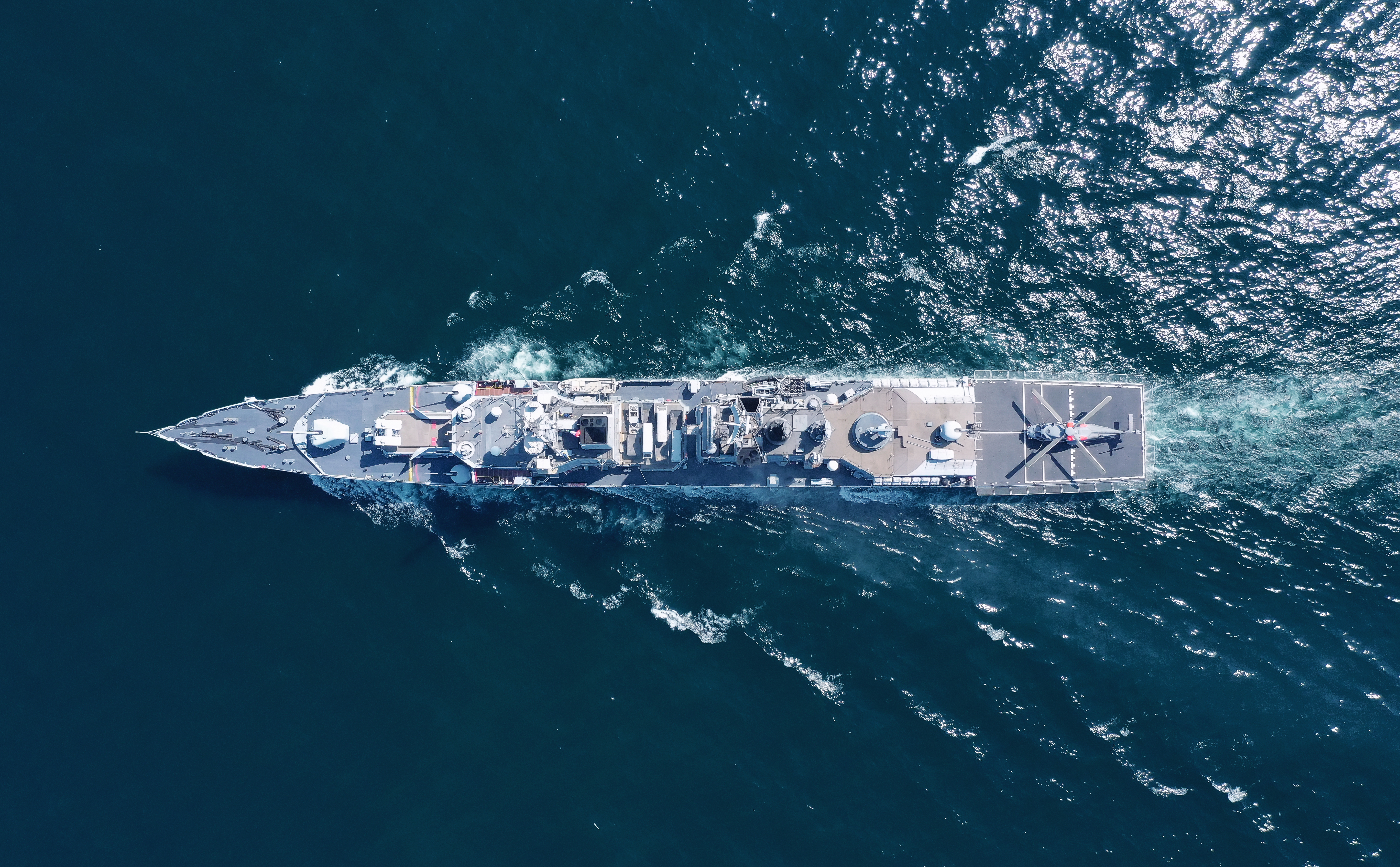 Aerial view of naval ship, battle ship, warship, Military ship resilient and armed with weapon systems, though armament on troop transports. support navy ship. Military sea transport.
