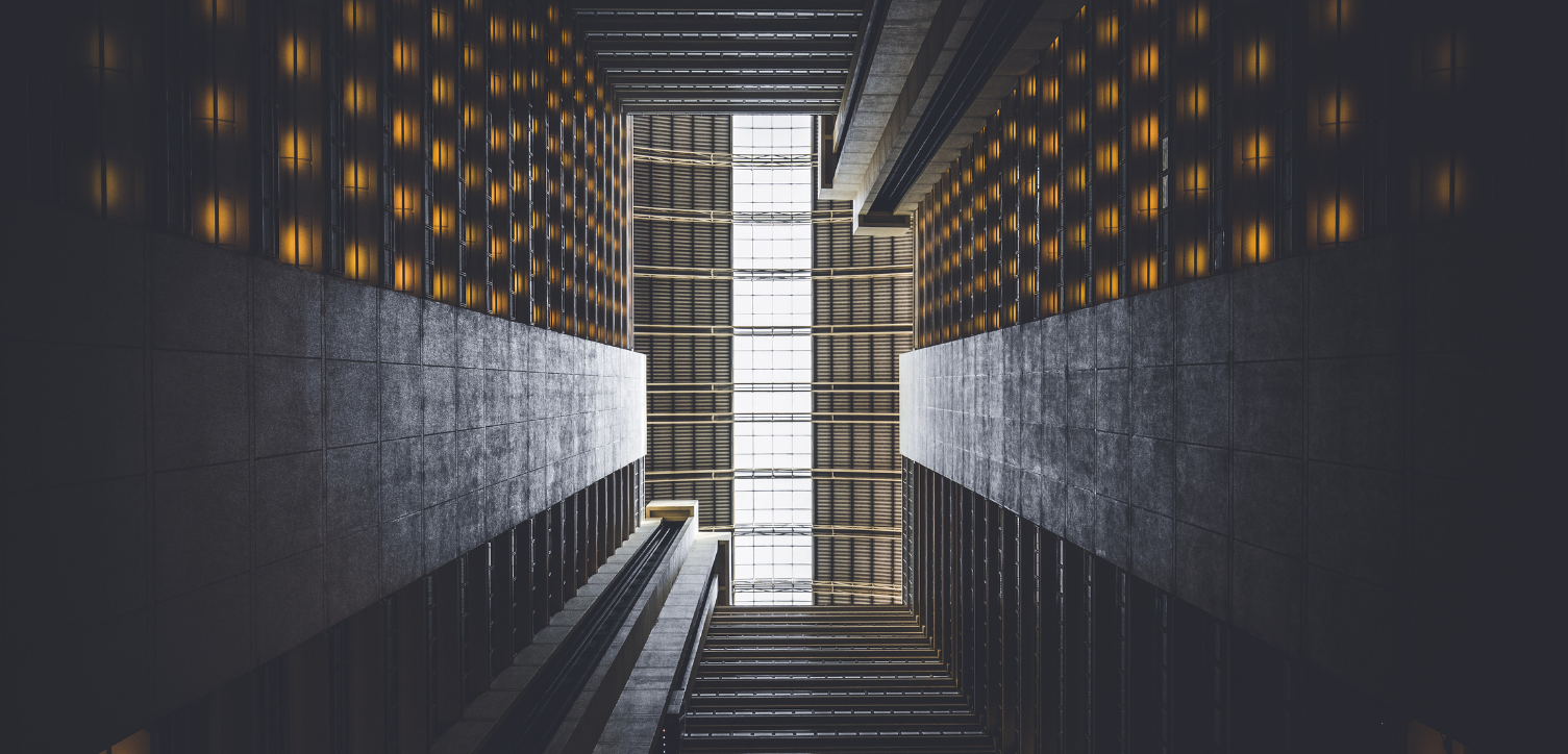 Internal office block walls with sunlight looking up