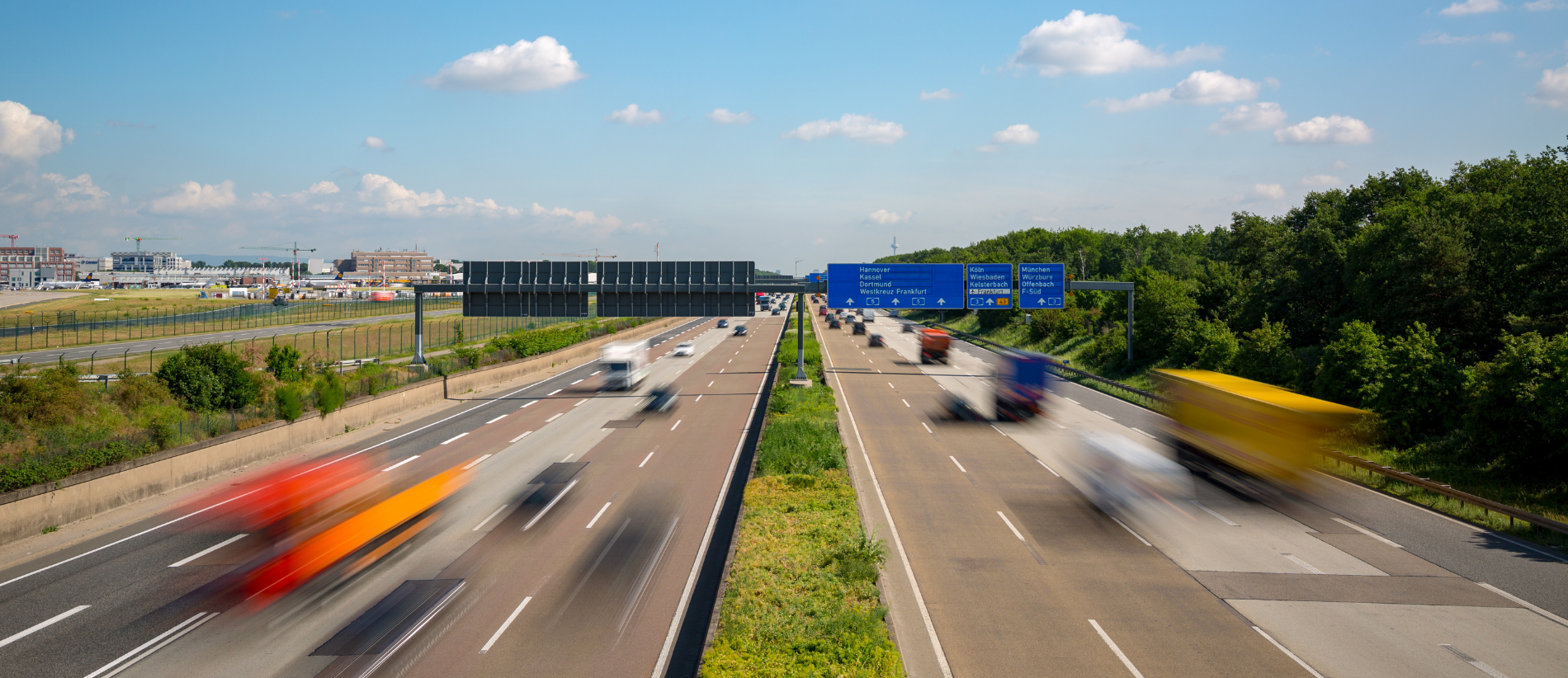 Multilane Autobahn highway with blurred trucks and cars near Frankfurt Airport, Frankfurter Kreuz, Germany. Transportation.