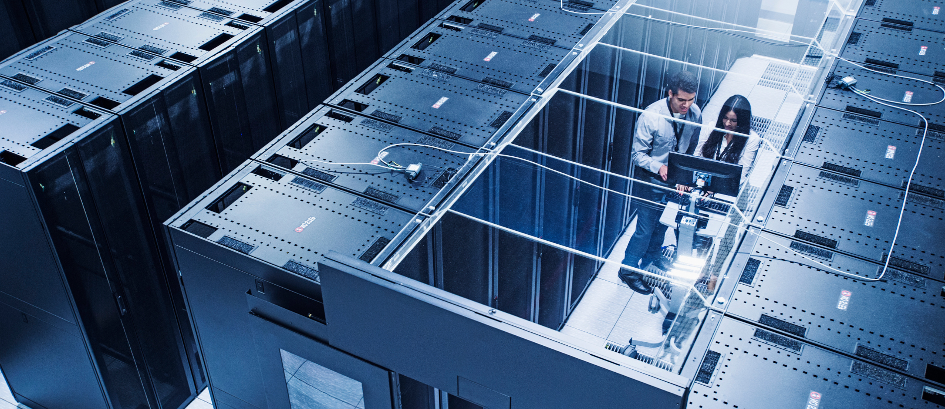 High angle view of technicians working in server room, cyber