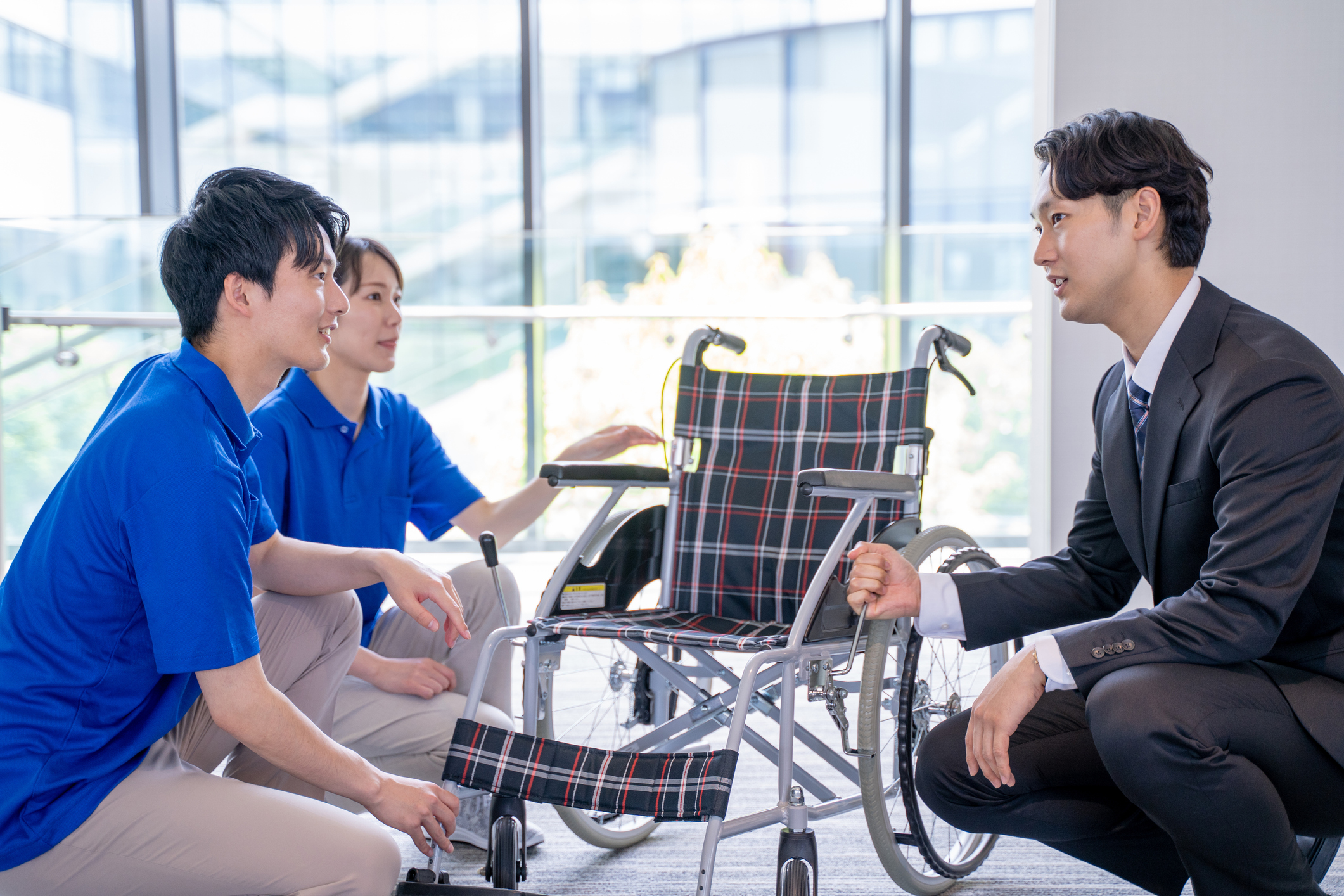 Businessman and care staff explaining about wheelchairs