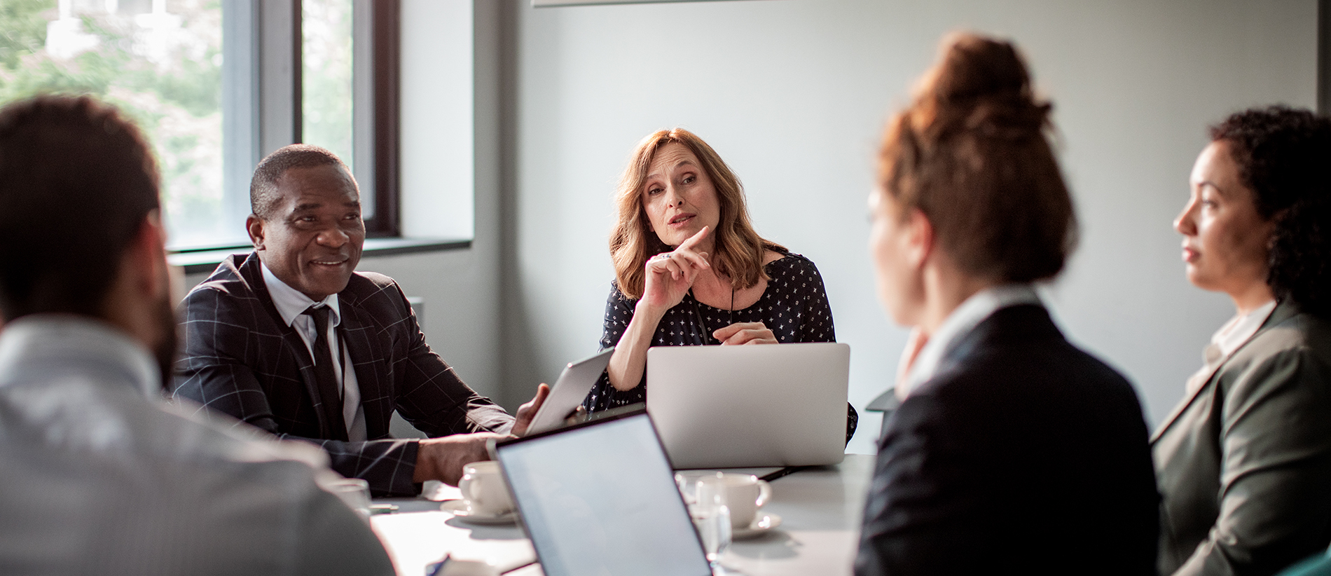 Close up of a group of business people having a meeting in a conference room