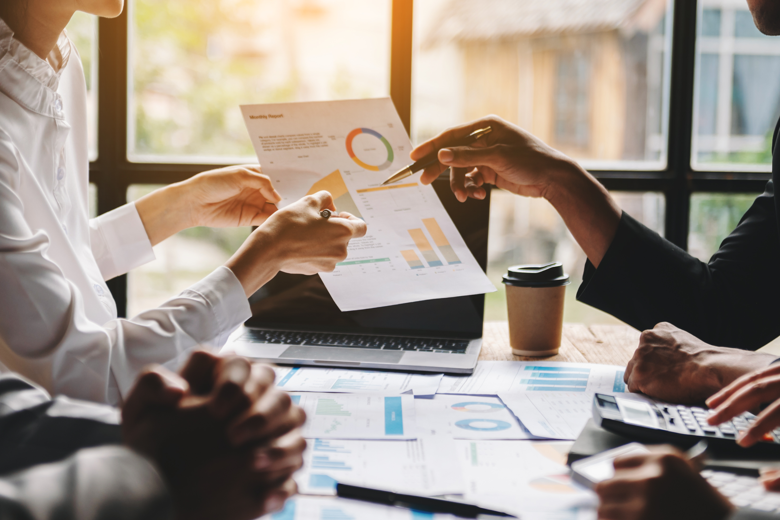 Team business meeting presentation. Hand businessman working project in modern office.Laptop computer and tablet and smart phone on white desk