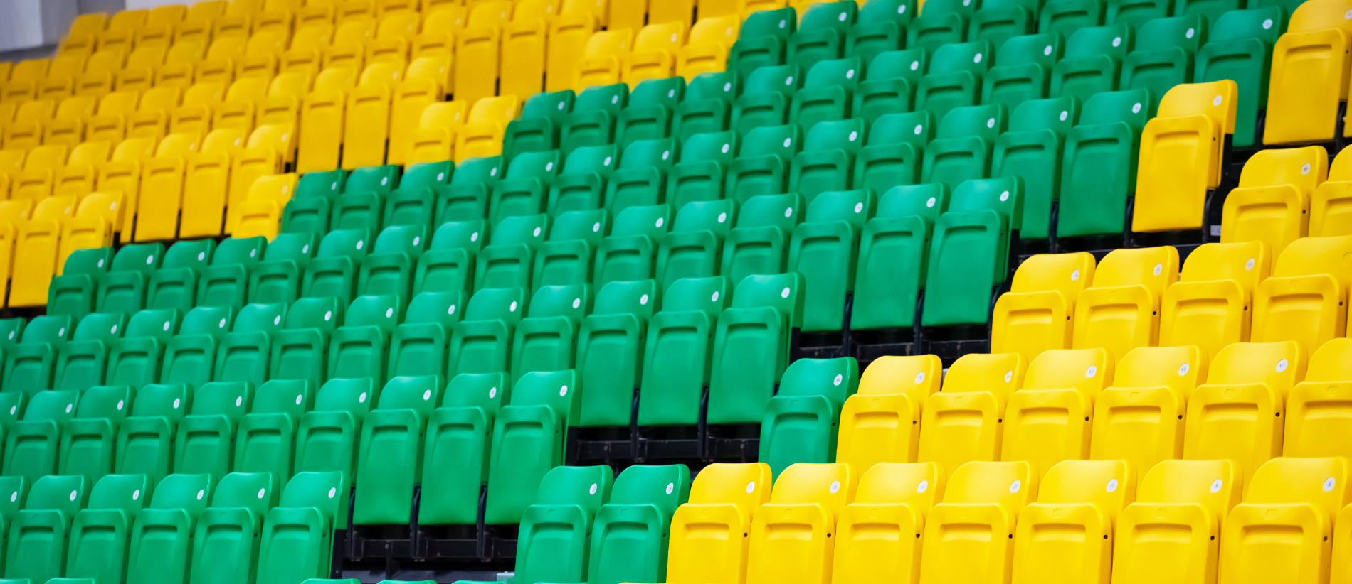 The empty seats at the stand of the outdoor sport stadium.empty coloured chairs
