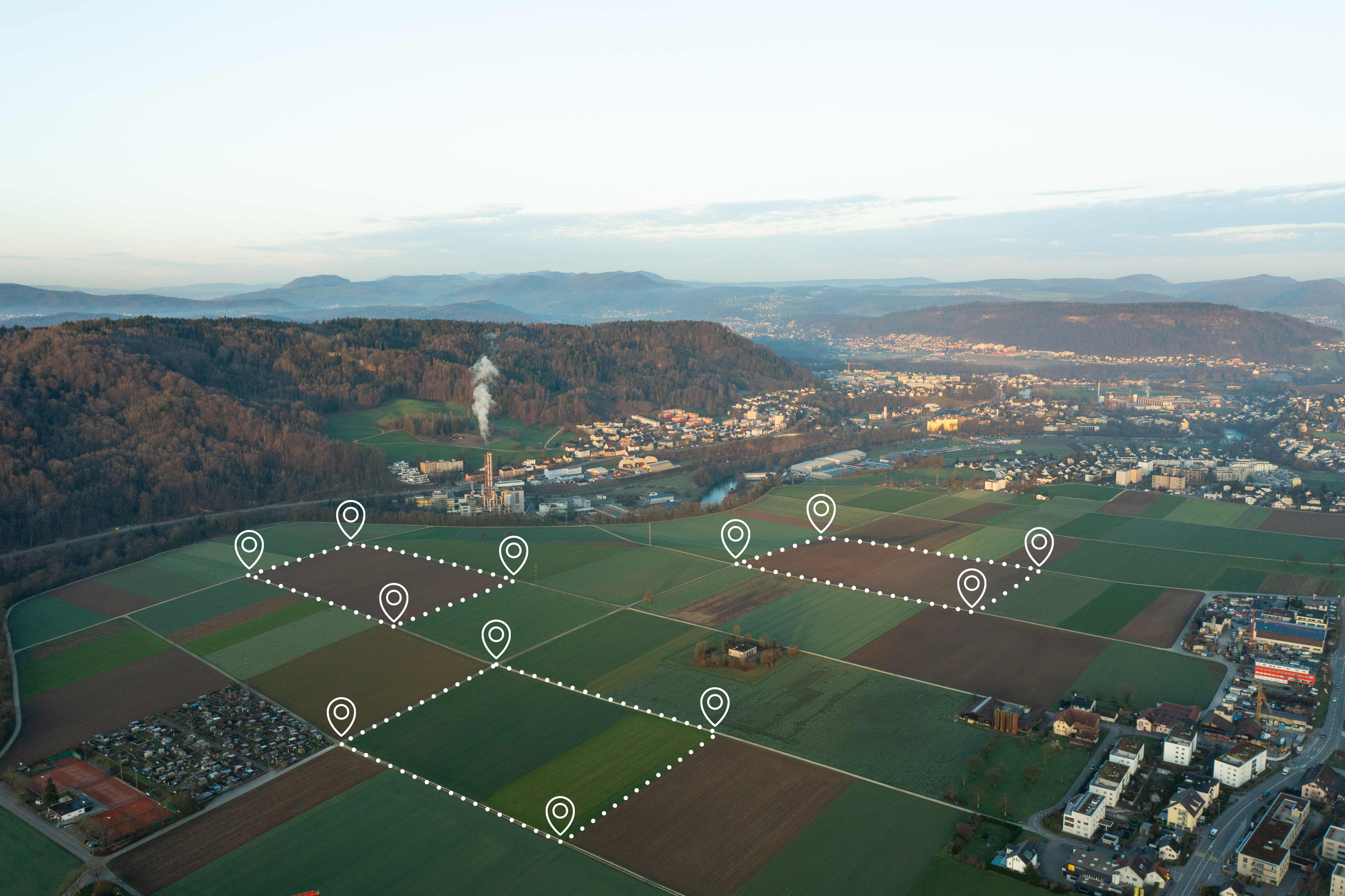 Land plot in aerial view. Identify registration symbol of vacant area for map. That property, real estate for business of home, house or residential i.e. development, sale, rent, buy or investment. Land plot management - real estate concept with a vacant land parcel available for building construction - housing concept with a red house icon.