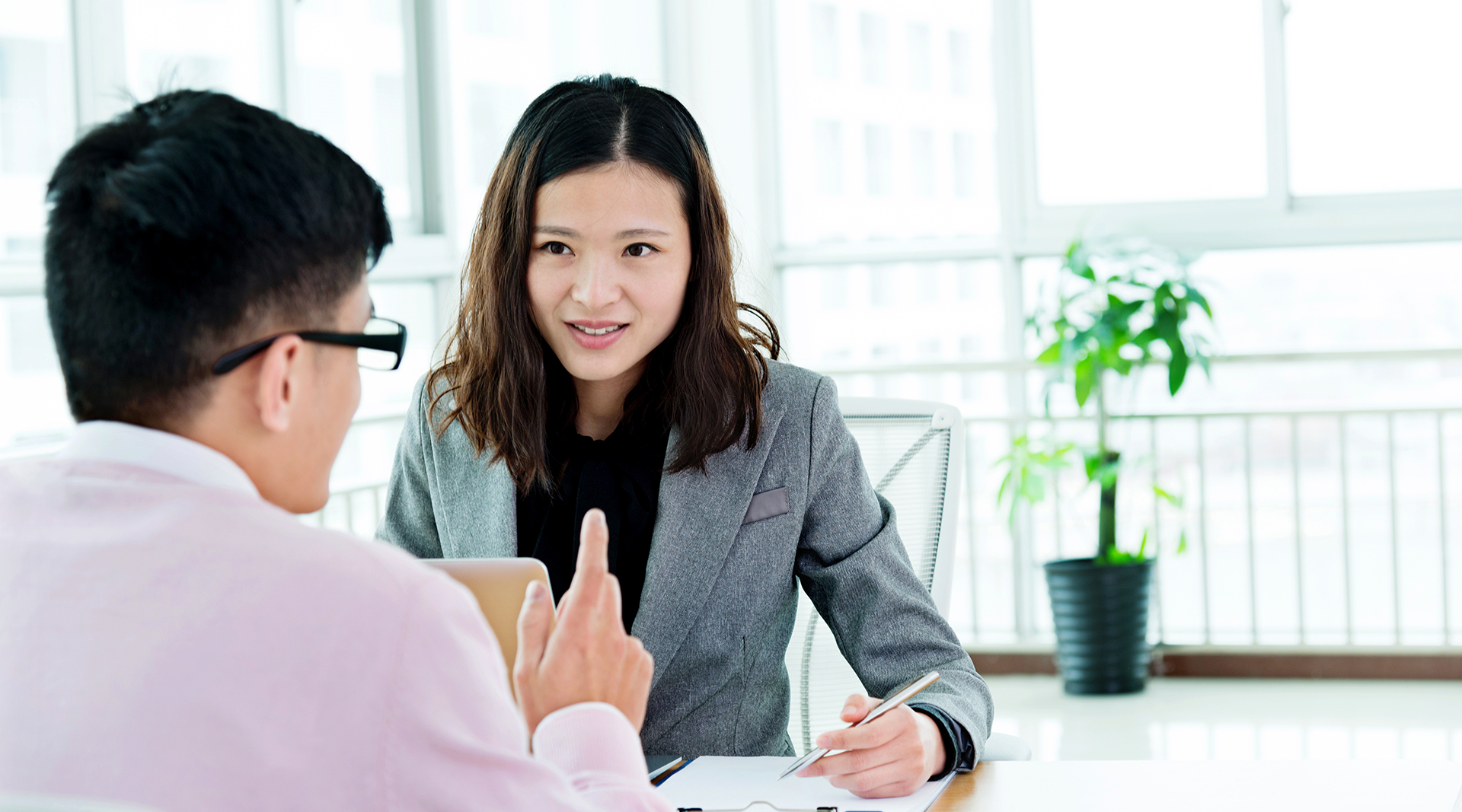 Chinese female advisor talking to client