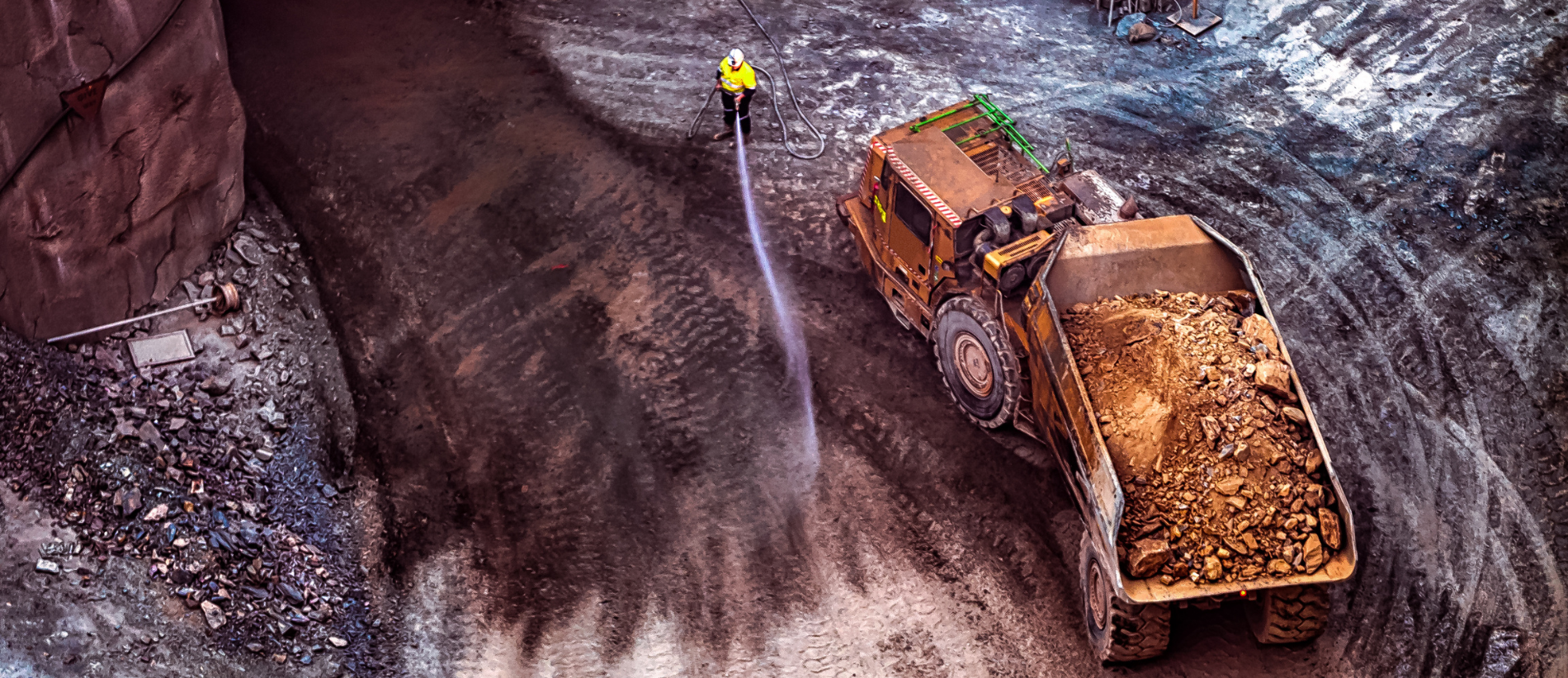 Two Dump trucks waiting to go Two Dump Truck at the bottom of an open cut mine