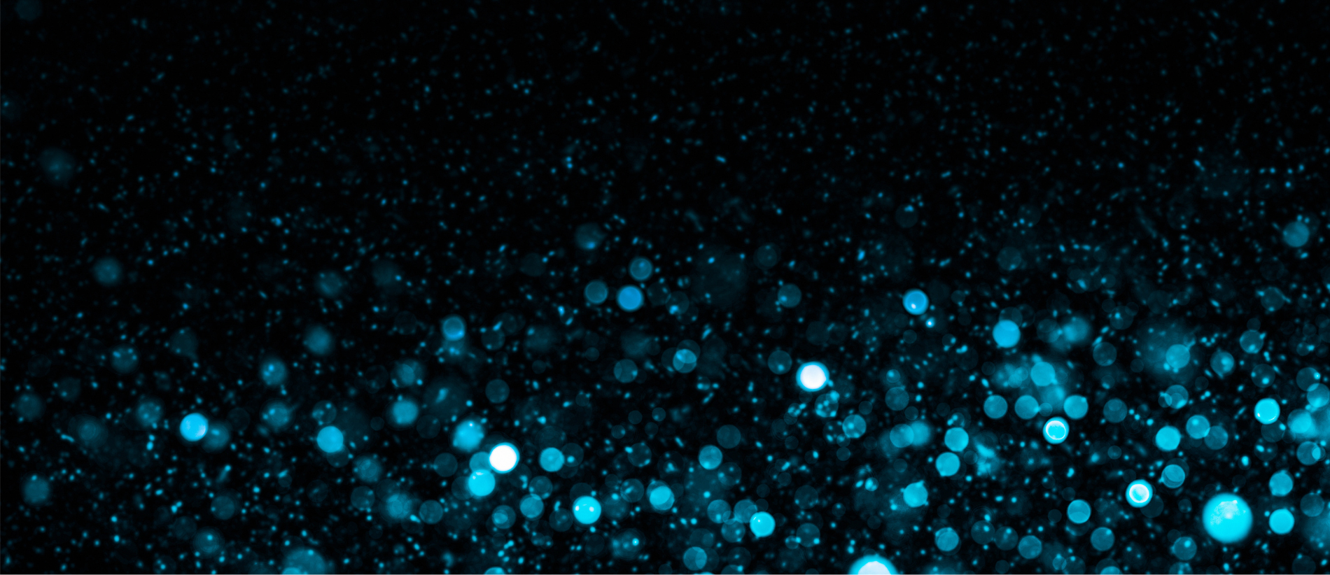 Defocused lights and dust particles over black background, abstract