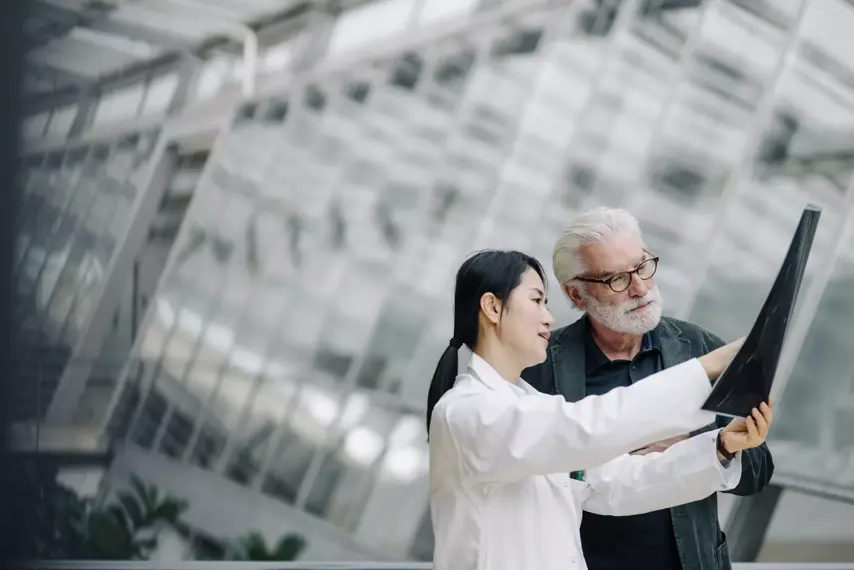Female doctor discussing x-ray with senior patient