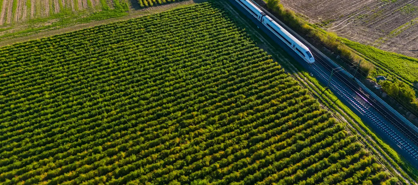 Aerial view of an electrified express ICE train on a railway track in rural area, Germany