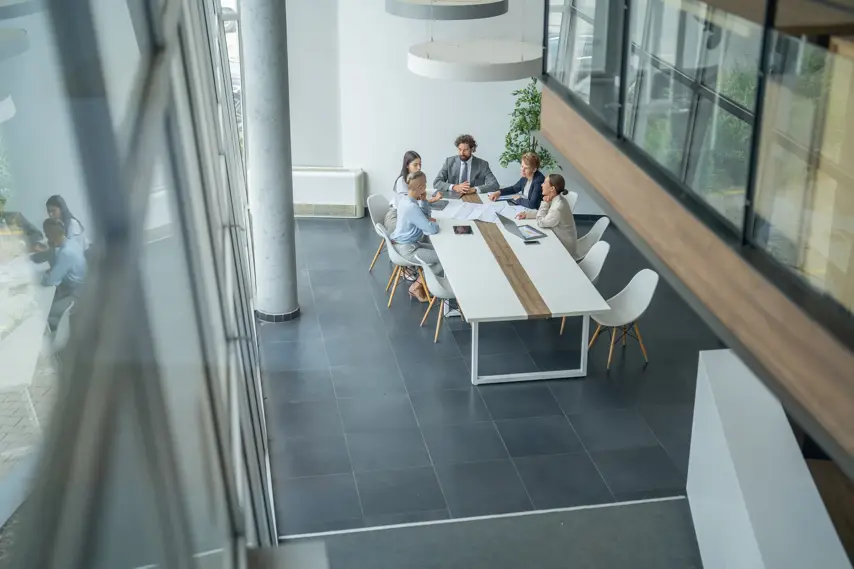Business team collaborating on a project, discussing ideas and strategies in a modern office environment