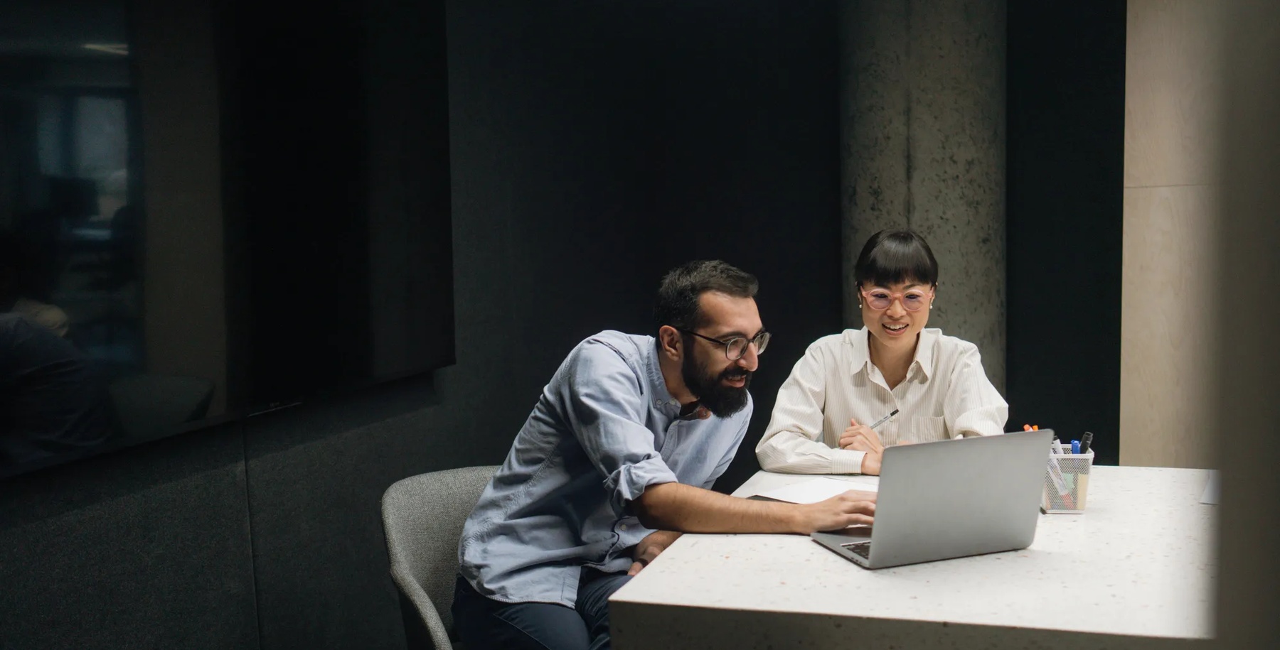 Photo of an Asian woman attending a meeting with her coworker