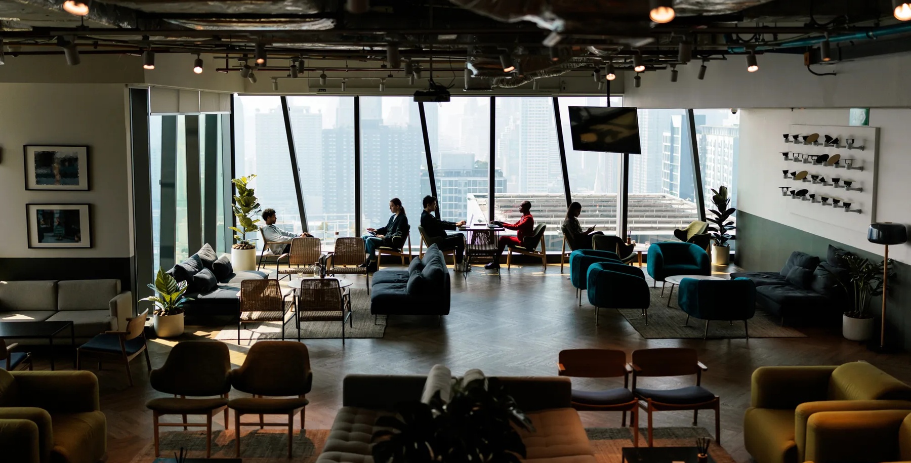 A modern and comfortable common room designed for employees, featuring cozy seating, warm lighting, and a welcoming atmosphere.
