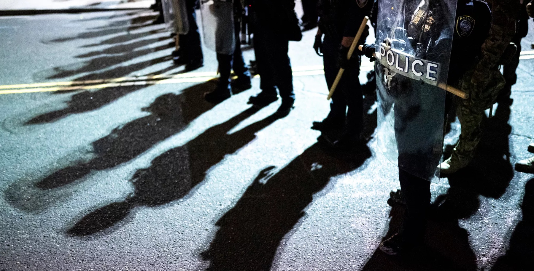 Police shields and shadows at activist protest