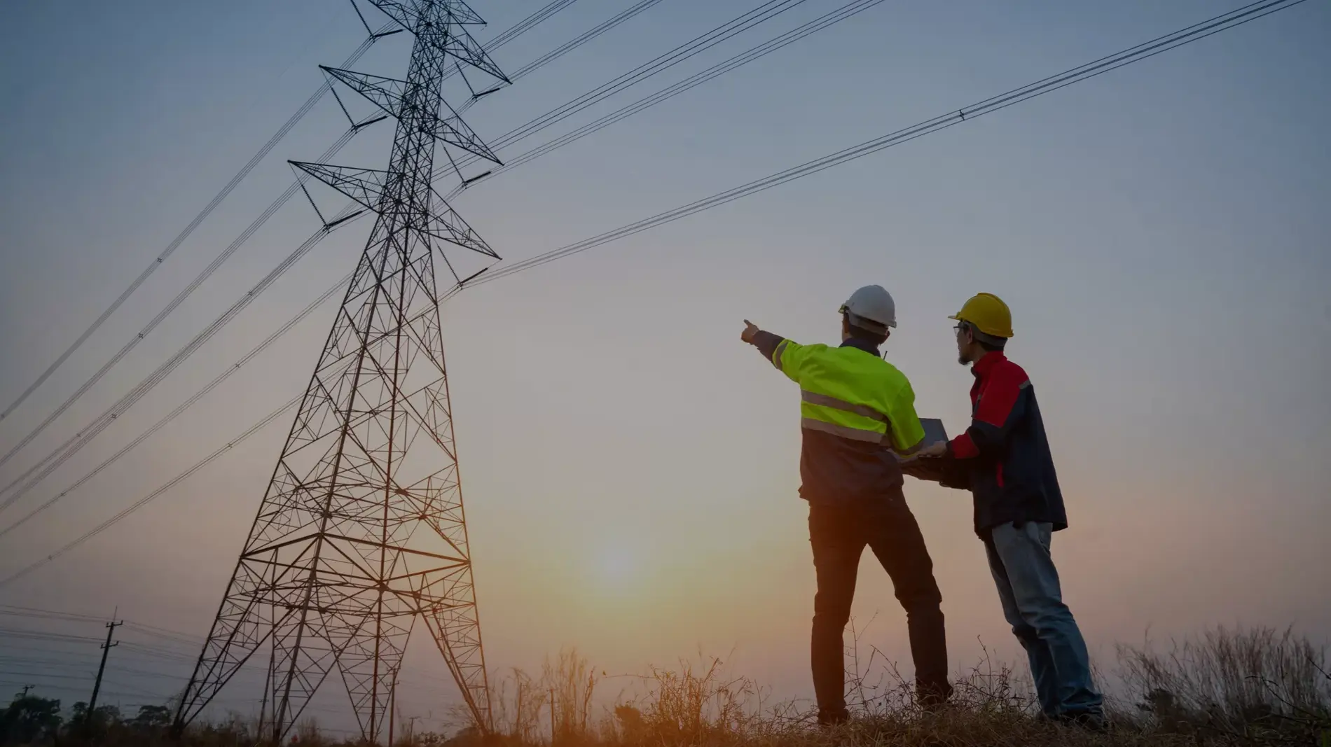 electrical engineer working at the power station See the planning of electricity production at high voltage poles.