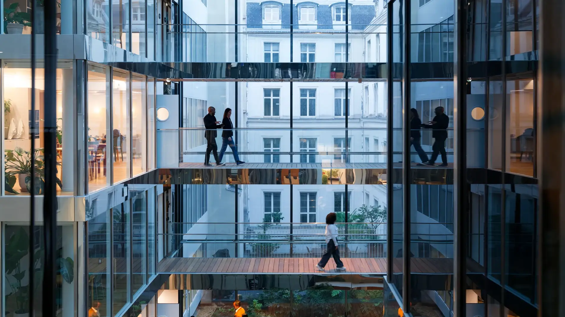 modern building in Paris, the walls are made of glass, at the end of the day, taken slightly against the light, wide view