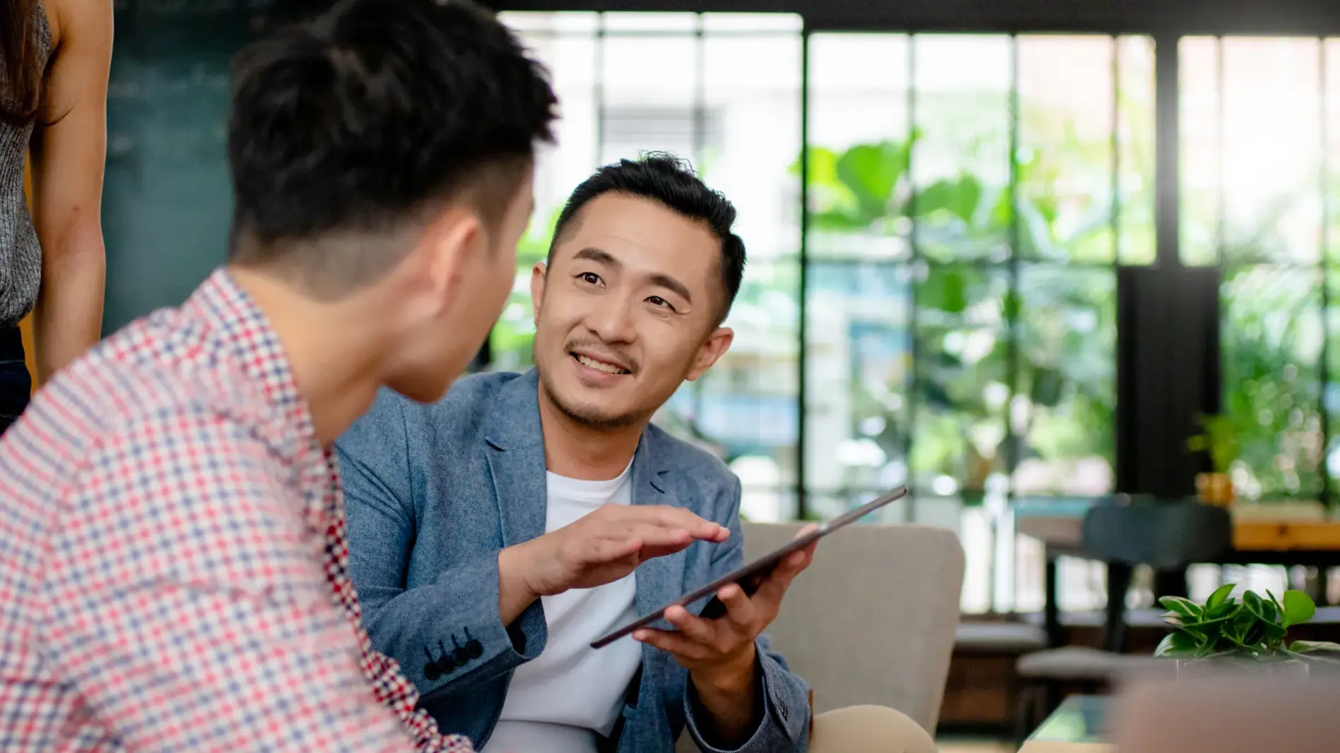Coworkers having an informal meeting in a modern office. Hong Kong 2019