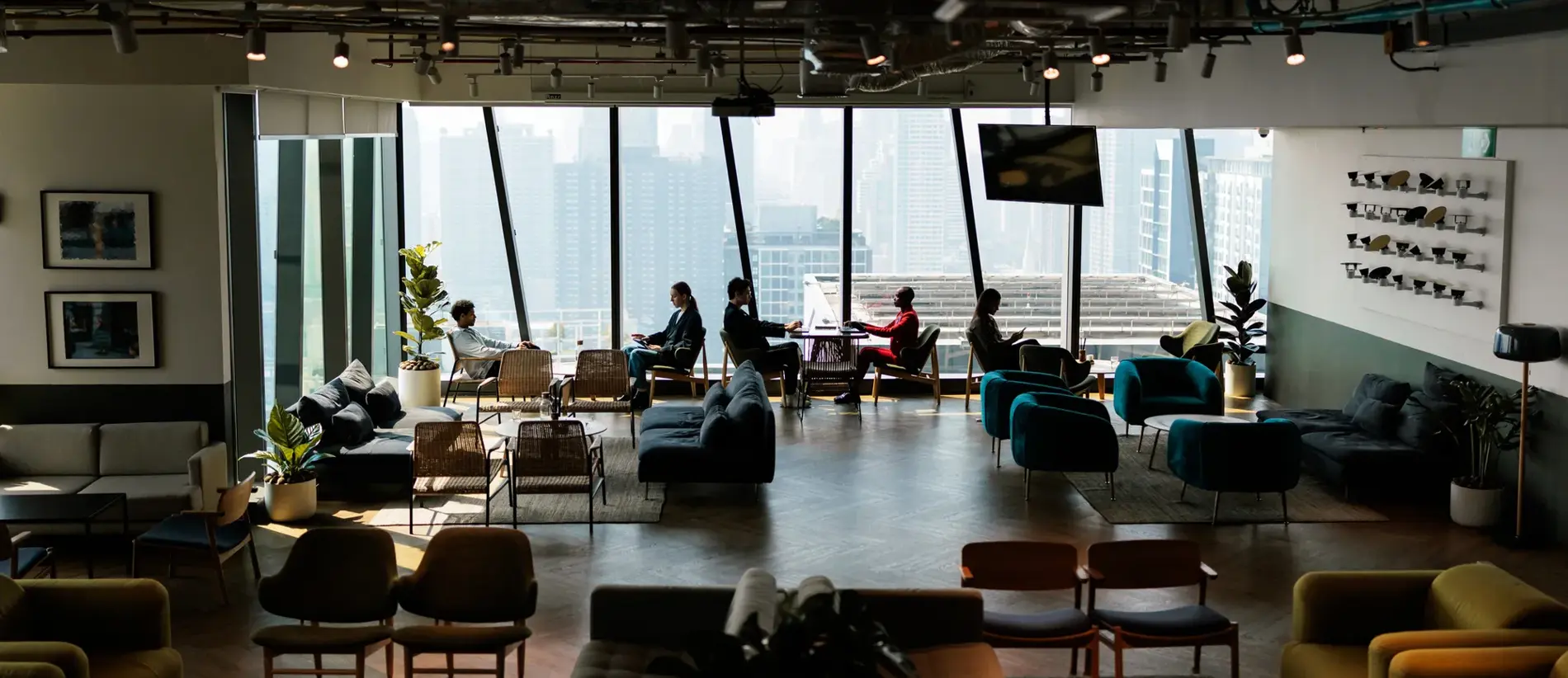 A modern and comfortable common room designed for employees, featuring cozy seating, warm lighting, and a welcoming atmosphere.