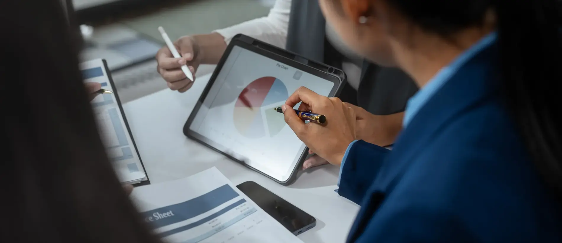 Entrepreneurs, marketers, managers, and financial analysts gather around the table to analyze data, present results, plan strategies, discuss efficiencies,grow their businesses through collaboration