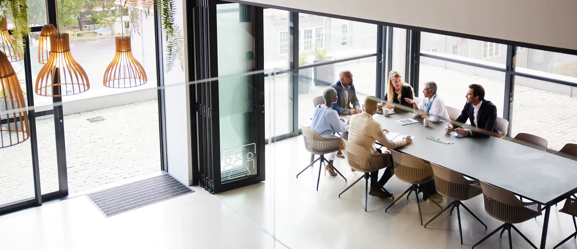 High angle view of a diverse group of businesspeople talking together around a conference table during a boardroom meeting in an office