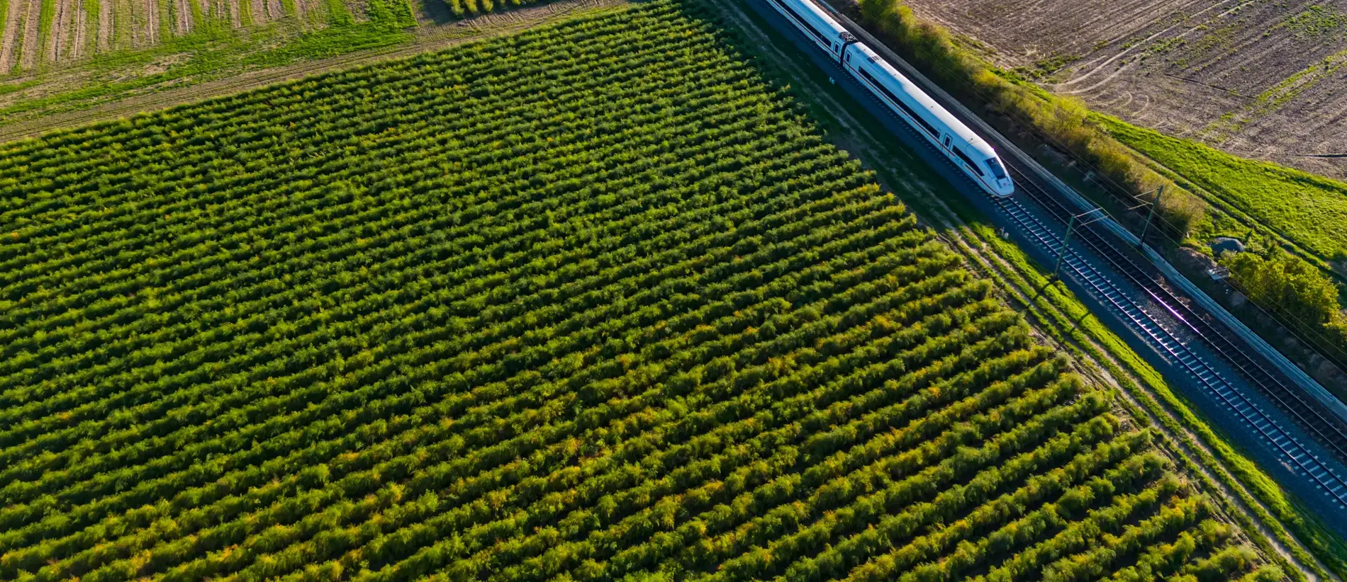Aerial view of an electrified express ICE train on a railway track in rural area, Germany