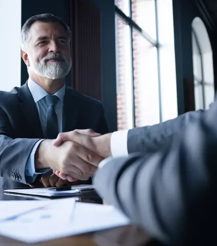 Good deal. Two business people shaking hands while sitting at the working place