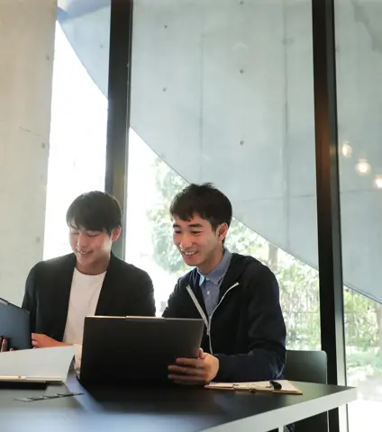 Asian Business colleagues standing together at a meeting in a modern office.