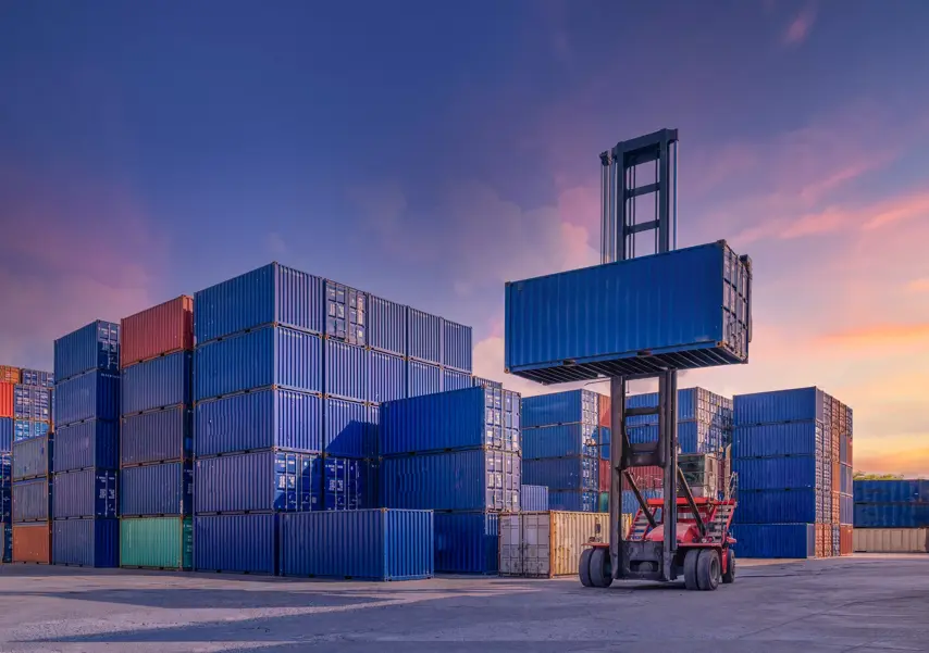Industrial Container yard for Logistic Import Export business and Forklift truck handling cargo shipping container box in logistic shipping yard with cargo container stack, Crane lifting up container in yard