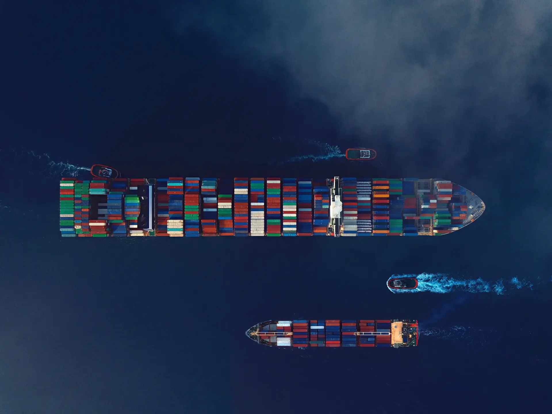 Directly above view of two cargo ships. High freight rates cast a shadow over economic recovery.