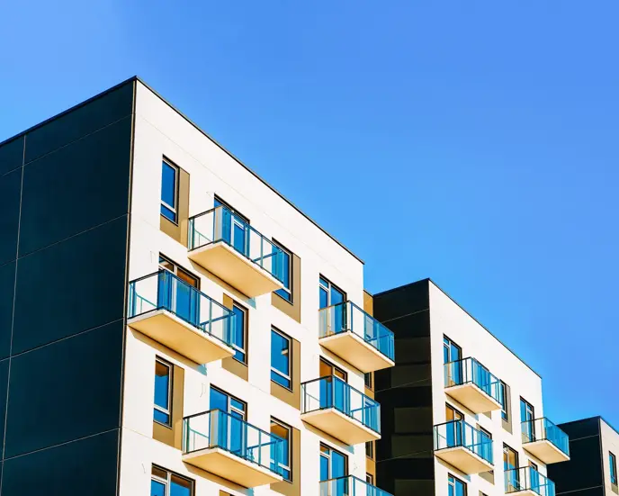Fragment of Modern residential apartment with flat buildings exterior. Detail of New luxury house and home complex. Part of City Real estate property and condo architecture. Copy space. Blue sky