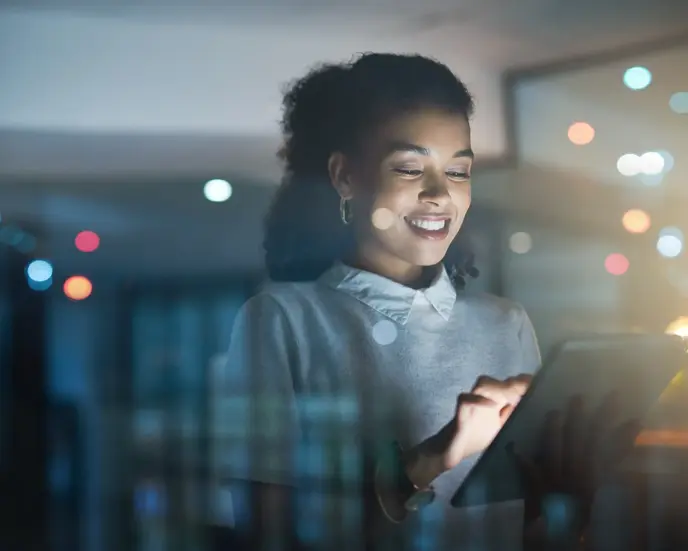 Shot of a young businesswoman using a digital tablet while working late in her office
