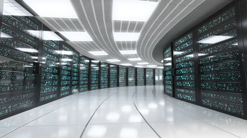 A long corridor within a data center features rows of servers on either side, illuminated by bright artificial lighting, creating a high-tech atmosphere.