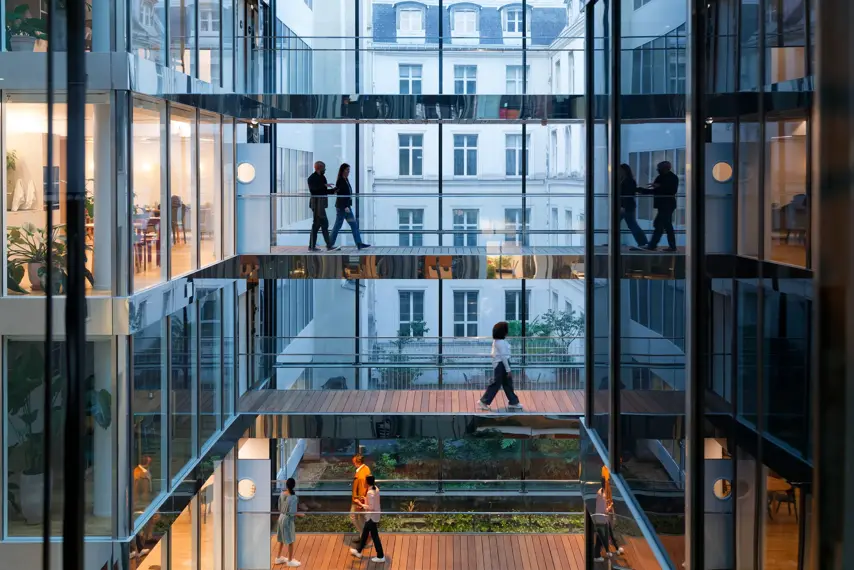 modern building in Paris, the walls are made of glass, at the end of the day, taken slightly against the light, wide view