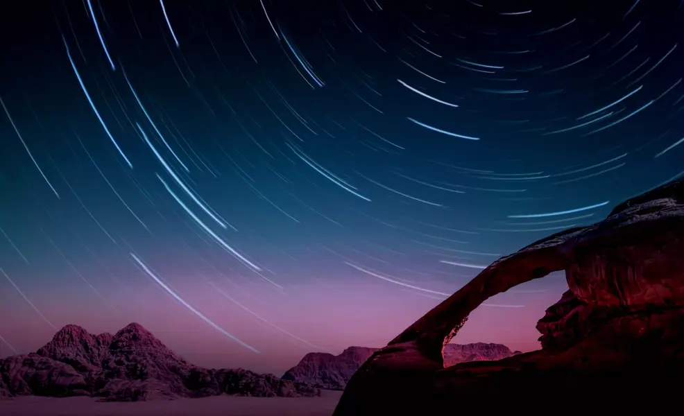 Image of mountains at dusk with stars
