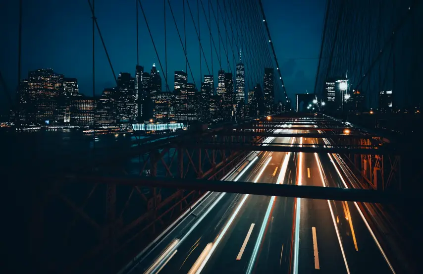 View from the top of the Brooklyn Bridge at night with Manhattan in the background