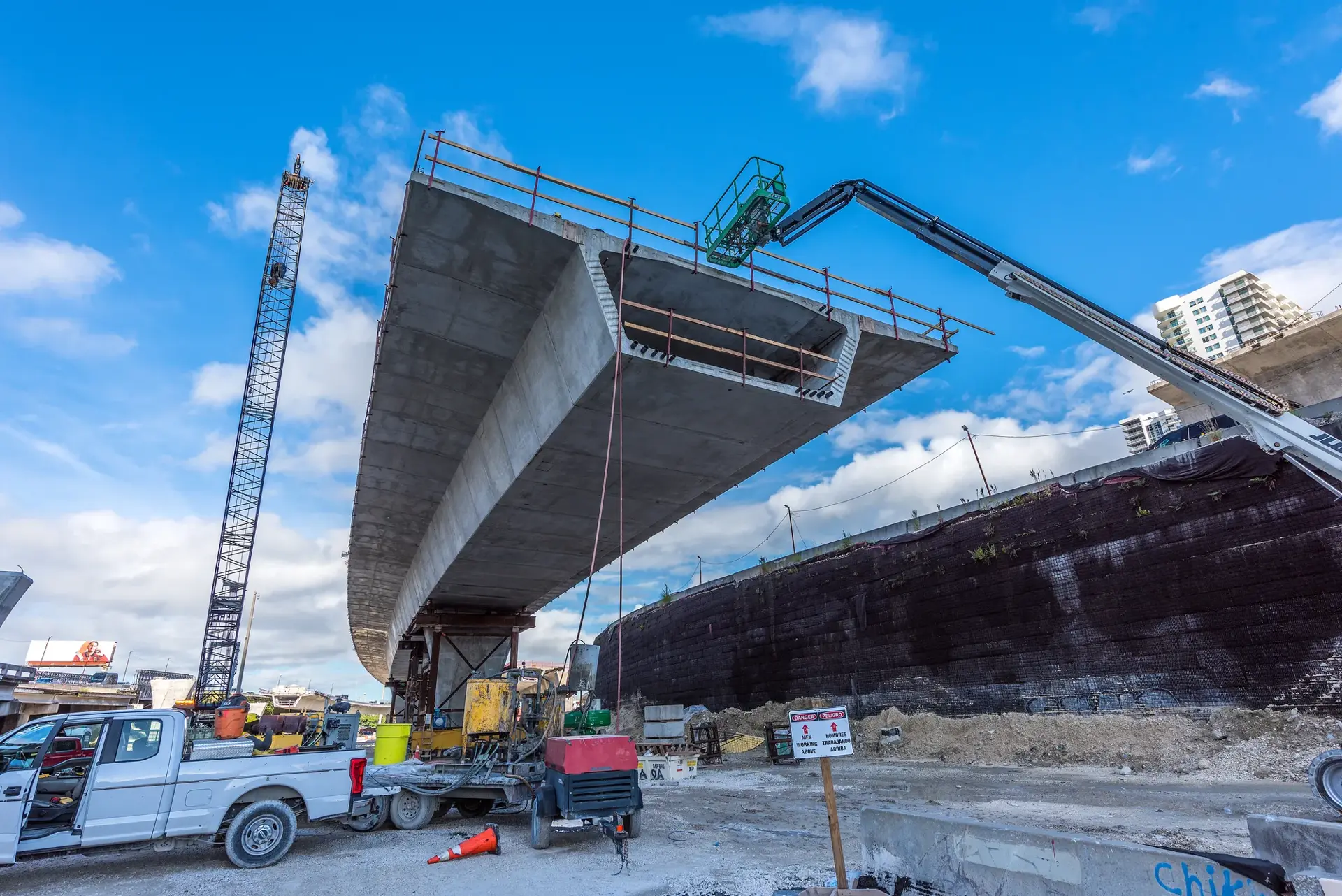Miami, Florida, USA - September 20, 2025: A group of workers inspect the intersection of the new overpass under construction (I-395/SR 836/I-95 Project) in northern Downtown Miami, where new luxury housing is being built.
