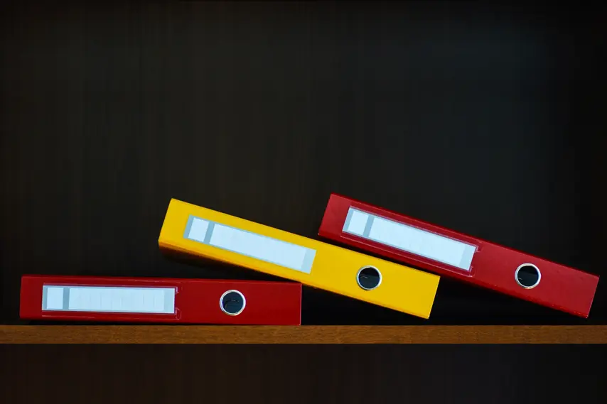 Folders for documents in the closet on the shelf in the office, files, copy space, background, close-up, office supplies
