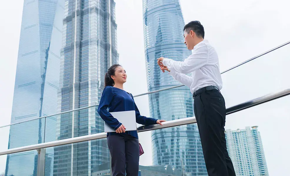 Business people talking in Shanghai - Greater China page - landing page carousel image 986x600px